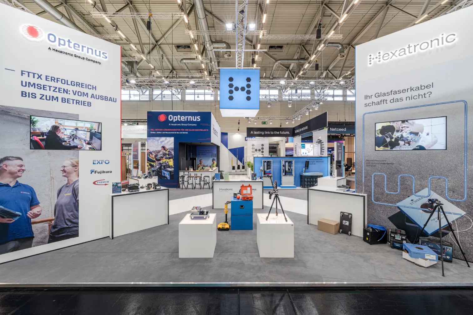 Messebau Köln – Opternus und Hexatronic Messestand mit Präsentationsflächen auf der AngaCom 2025.