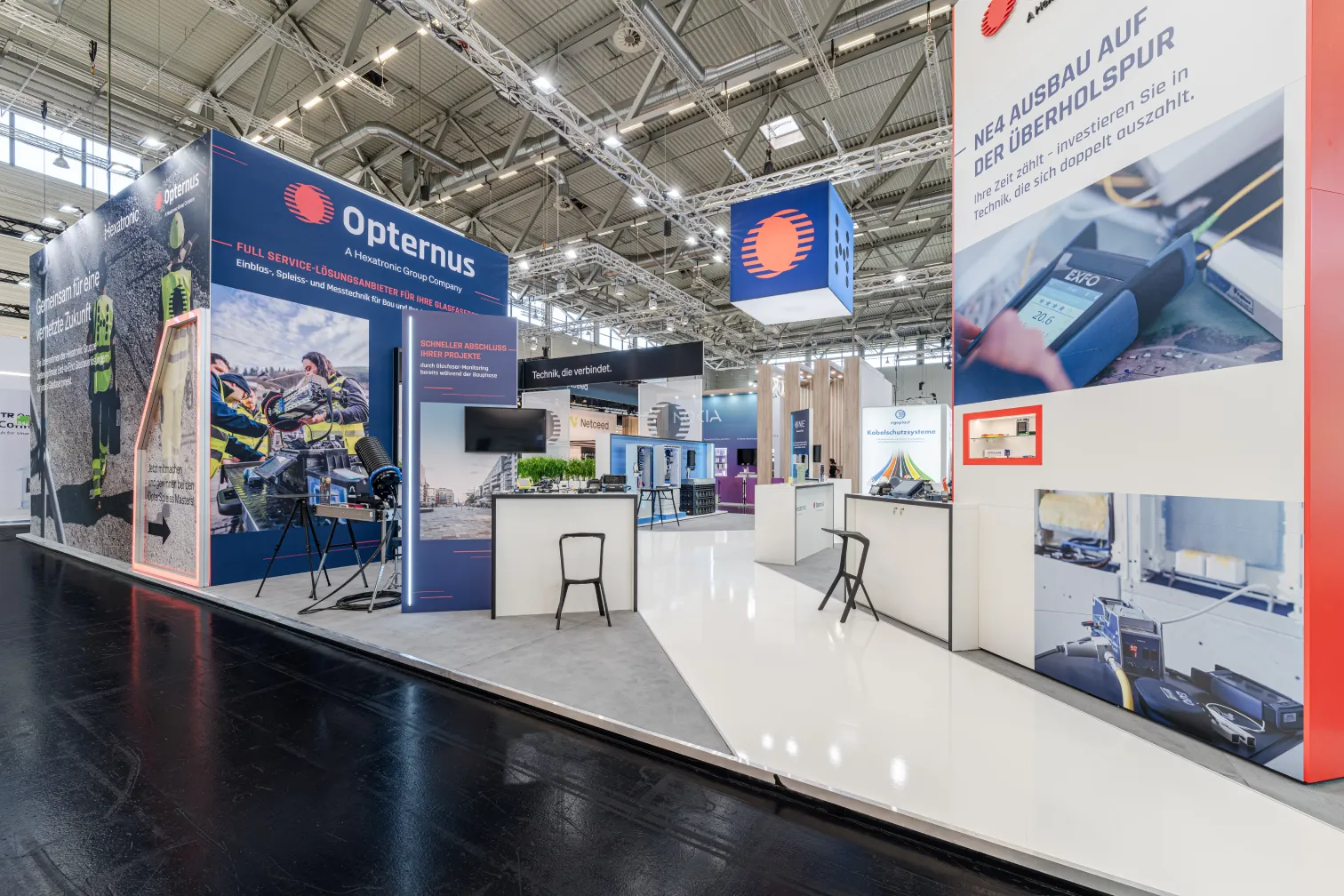 Messebau Köln – Opternus Messestand auf der AngaCom 2025 in Köln mit moderner Technikpräsentation.