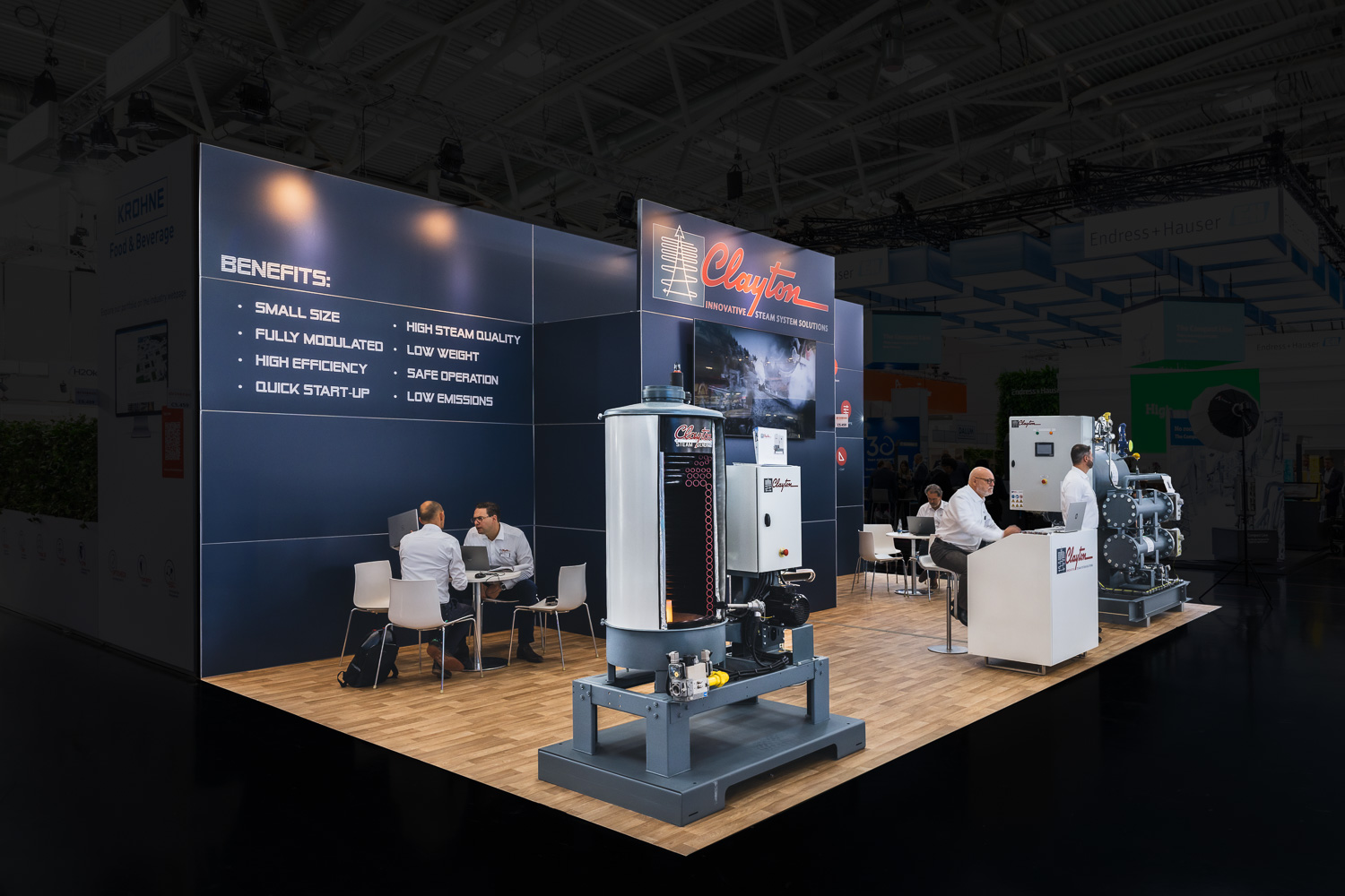Gesamtaufnahme des Clayton Messestands auf der Drinktec 2025 mit leistungsstarken Dampfanlagen und moderner Produktpräsentation – Messebau München.