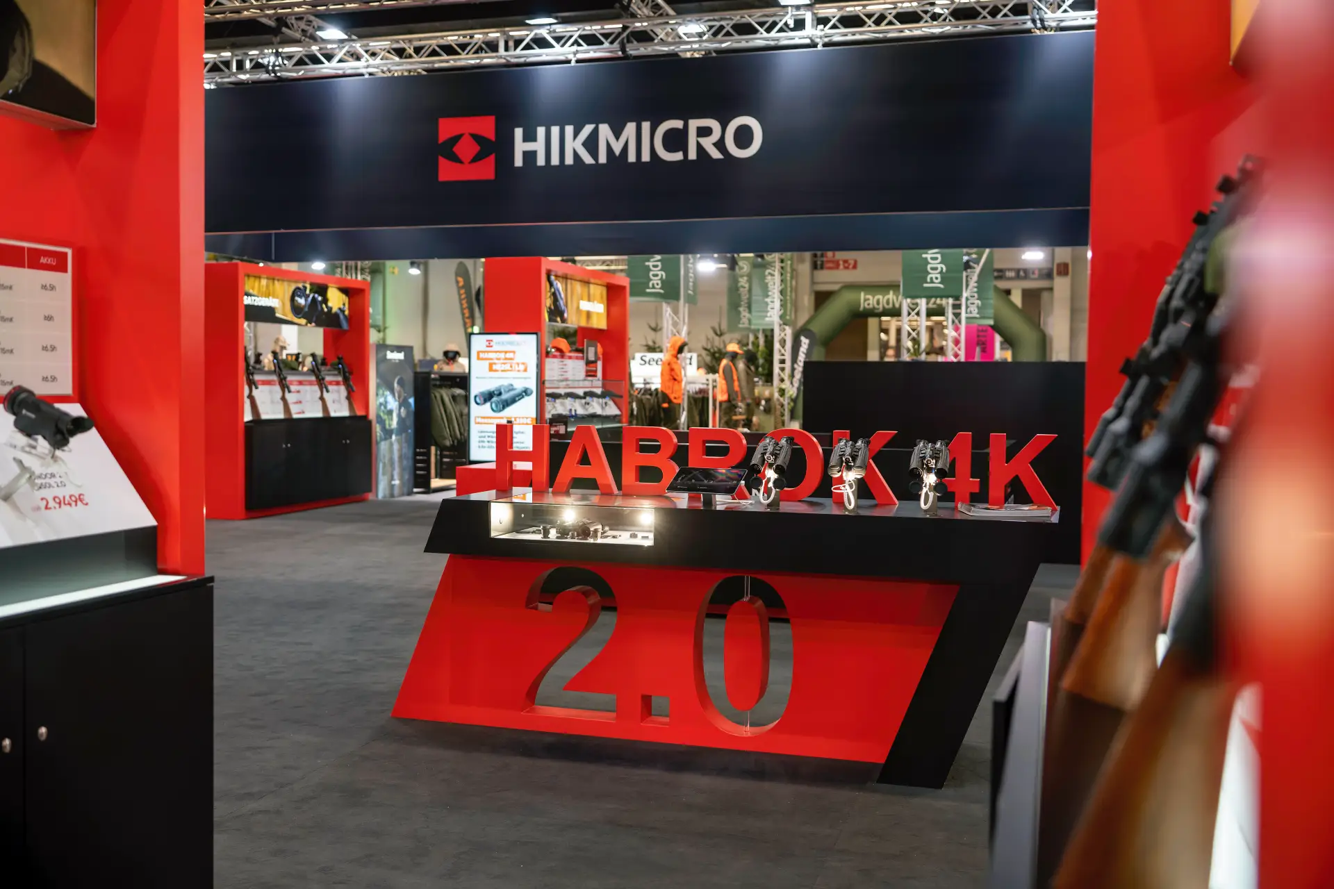 Blick auf den HIKMICRO-Messestand in Dortmund mit Logobanner, rot-schwarzem Habrok 4K 2.0 Tresen und ausgestellten Wärmebildgeräten.